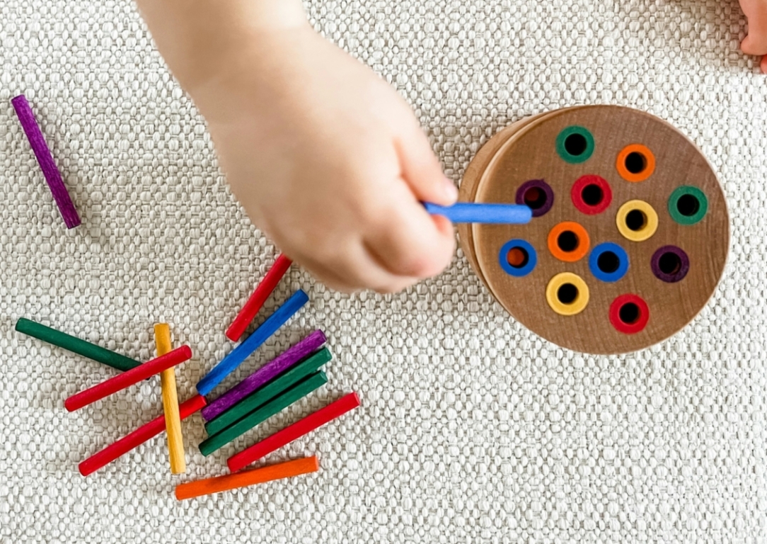 child playing with colour crayons at blue gum montessori school in perth