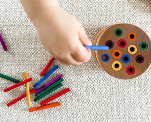 child playing with colour crayons at blue gum montessori school in perth