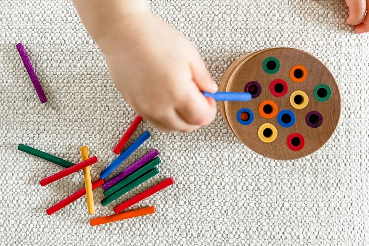 child playing with colour crayons at blue gum montessori school in perth