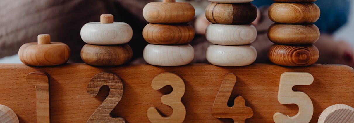 Close-up of wooden number stacking toy promoting creativity and learning in children.