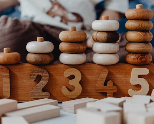 Close-up of wooden number stacking toy promoting creativity and learning in children.